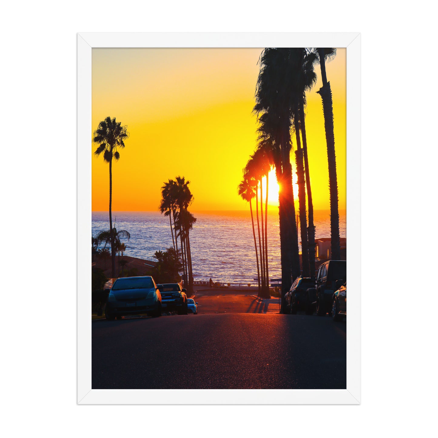 A golden sunset glows at the end of Palomar Avenue, framed by coastal palms and neighborhood silhouettes in La Jolla; white frame, 18 × 24 inches.