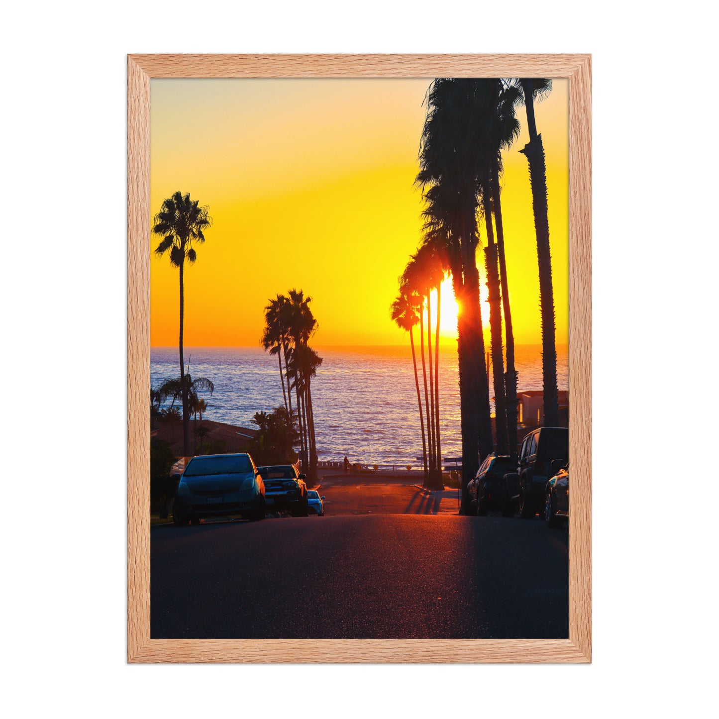 A golden sunset glows at the end of Palomar Avenue, framed by coastal palms and neighborhood silhouettes in La Jolla; wood frame, 18 × 24 inches.