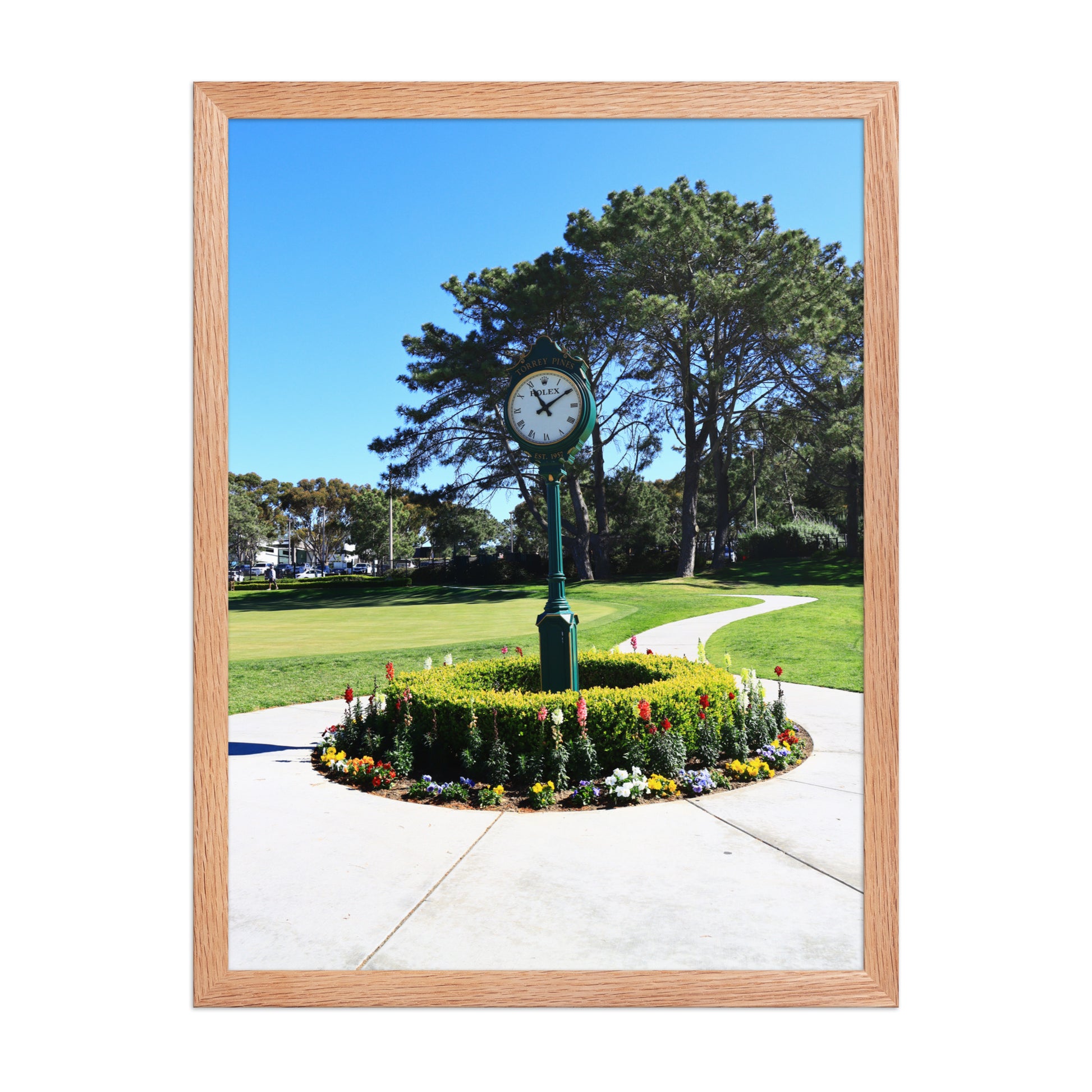 The course clock and surrounding landscaping create a recognizable arrival scene at Torrey Pines in La Jolla; wood frame, 18 × 24 inches.