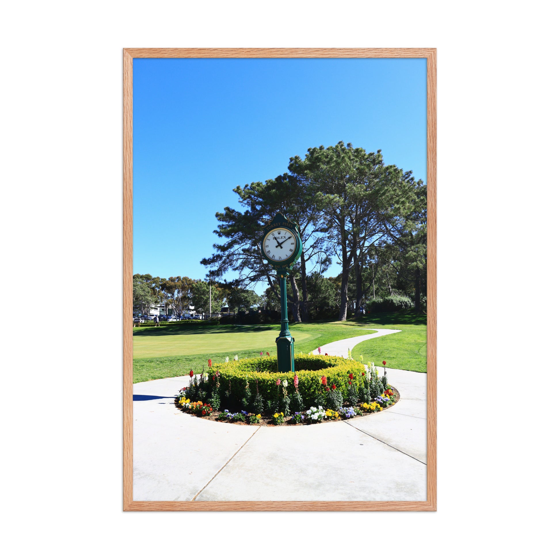 The course clock and surrounding landscaping create a recognizable arrival scene at Torrey Pines in La Jolla; wood frame, 24 × 36 inches.
