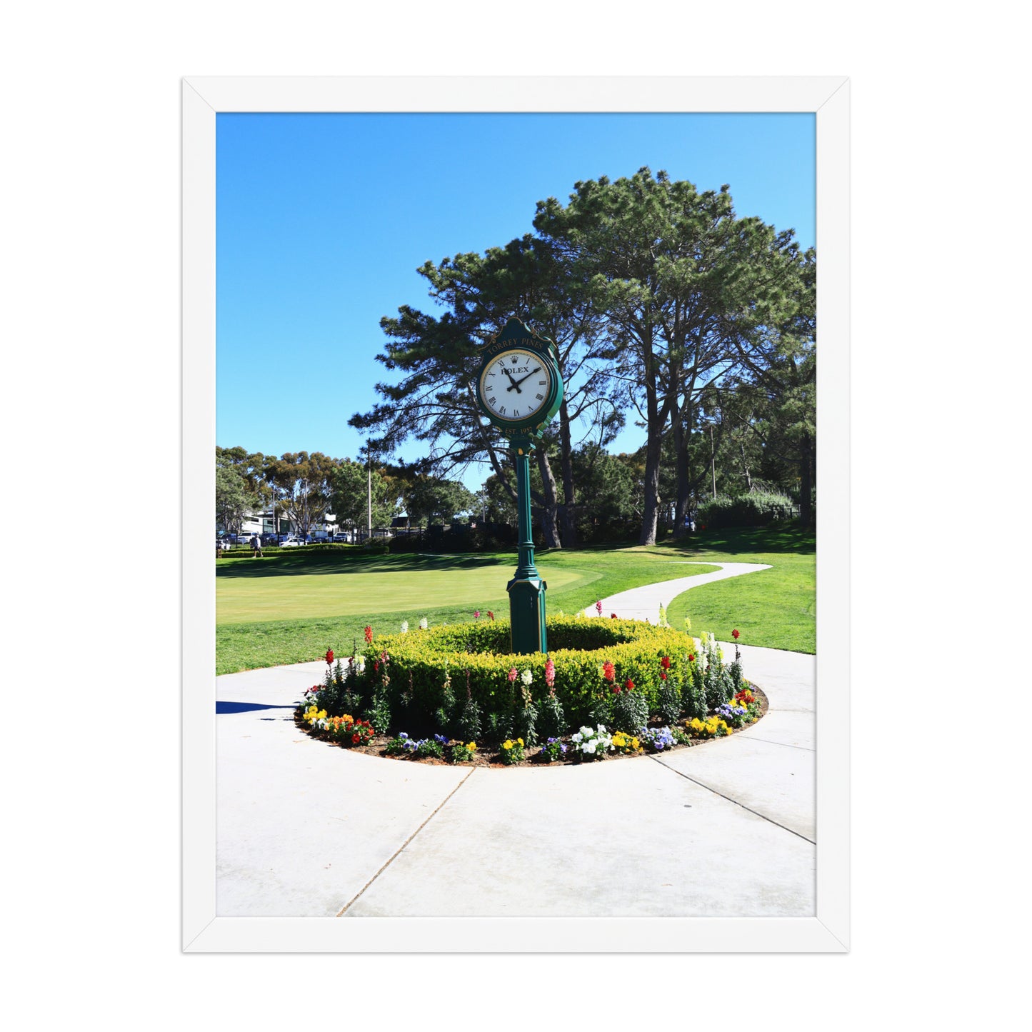 The course clock and surrounding landscaping create a recognizable arrival scene at Torrey Pines in La Jolla; white frame, 18 × 24 inches.