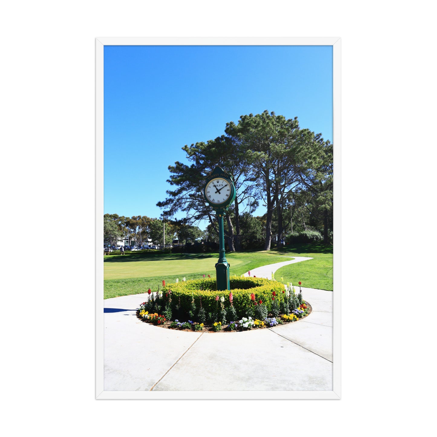 The course clock and surrounding landscaping create a recognizable arrival scene at Torrey Pines in La Jolla; white frame, 24 × 36 inches.