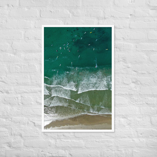 Surfers wait beyond parallel lines of breaking waves in this overhead view of the La Jolla coast; white frame, 24 × 36 inches.