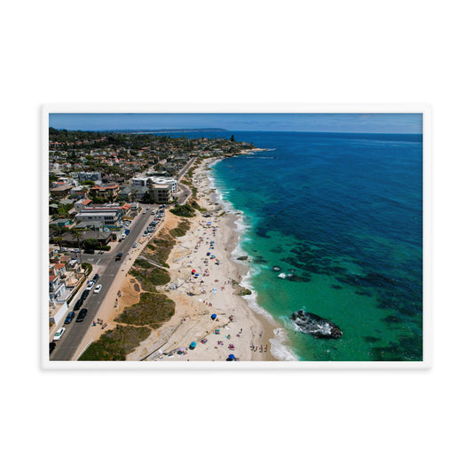 A broad coastal view follows Windansea's pale sand, rocky shoreline, and clear summer water in La Jolla; white frame, 24 × 36 inches.